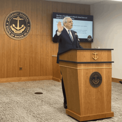 A man in a suit standing at a podium.