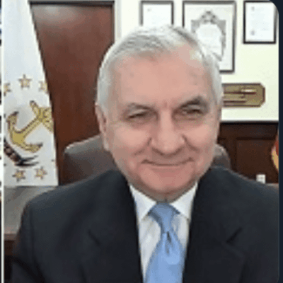 A man in a suit and tie sitting in an office.