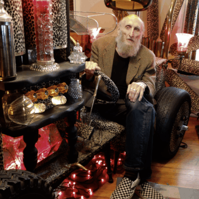 A man sitting on a car.