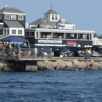 A boat docked next to a building on the water.