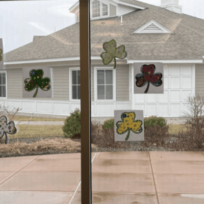 St patrick's day decorations in the windows of a house.