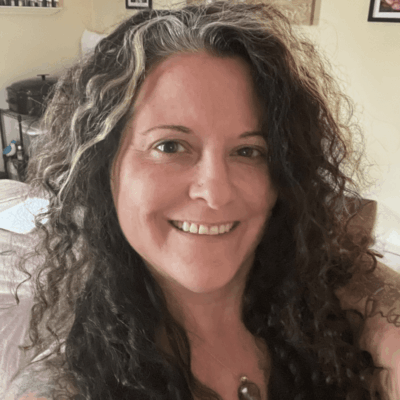 A woman with curly hair in a room with the words relax.