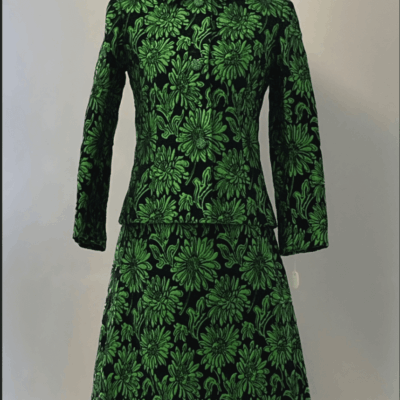 A green floral dress on a mannequin.
