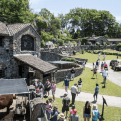A group of people standing in front of a stone building.