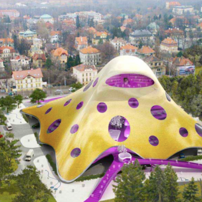 An aerial view of a purple building in the middle of a city.