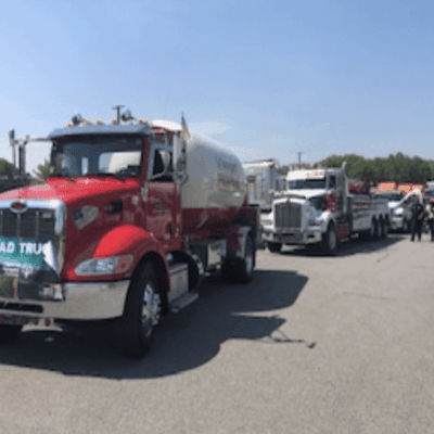 A group of trucks parked in a parking lot.