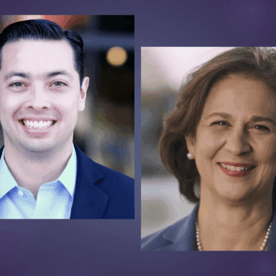 Two people smiling in front of a purple background.