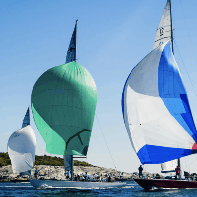 A group of sailboats in the water.