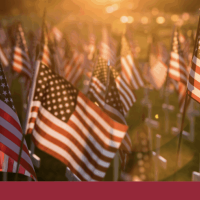 A group of american flags in a field.