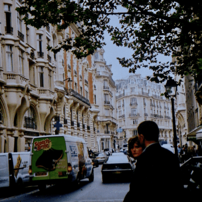 A man and woman walking down a city street.