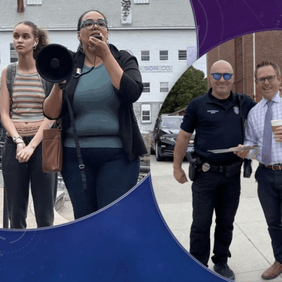 A group of people standing in front of a police officer.