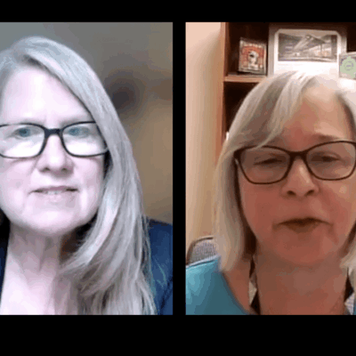 Two women in glasses are talking on a video call.