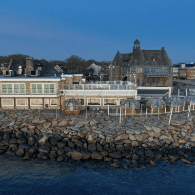 An aerial view of a restaurant on a rocky shore.