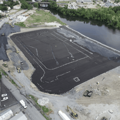 An aerial view of a construction site near a river.