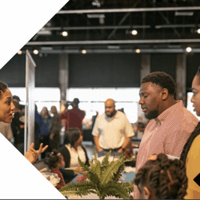 A group of people talking to each other at an event.