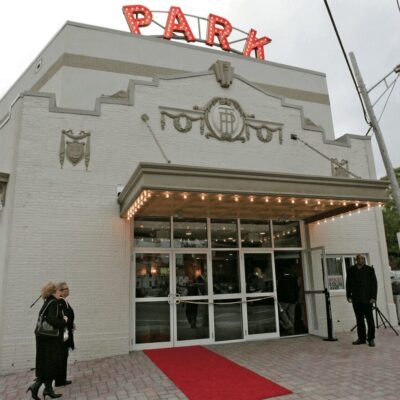 A white building with a red carpet.