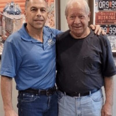Two men standing next to each other in a store.