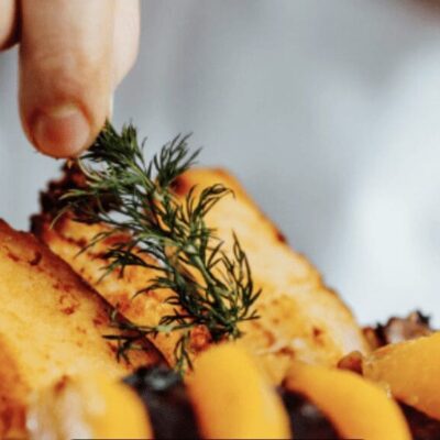 A person is holding a plate of food.