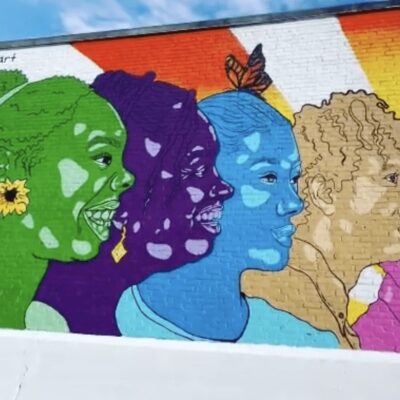 A colorful mural depicting a group of people.