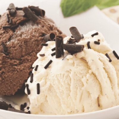 Two scoops of ice cream on a plate.