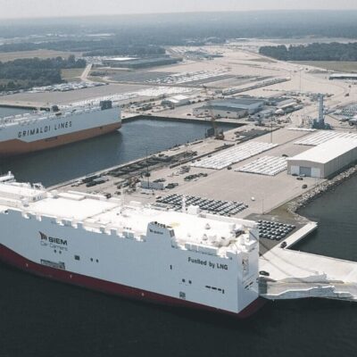 Two large ships docked in a large body of water.