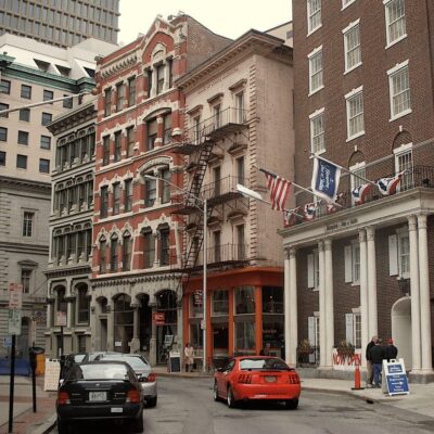 A car is driving down a city street.