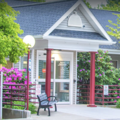 The front of a building with a bench in front of it.