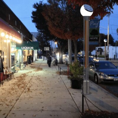 A street with cars parked on it at dusk.