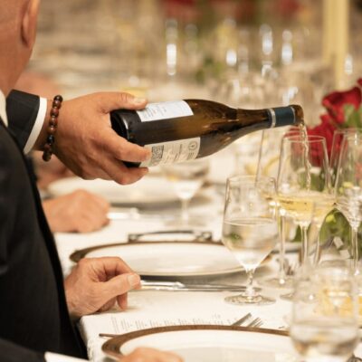 A man pouring a bottle of wine.