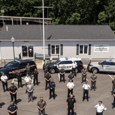 A group of police officers standing in front of a building.