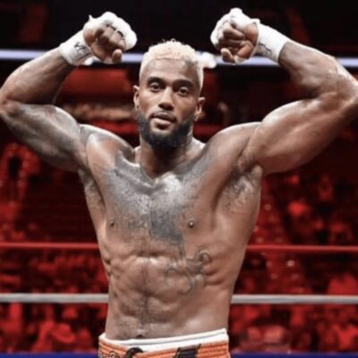 A boxer posing for the camera in a boxing ring.