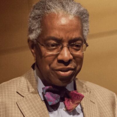 A man wearing glasses and a bow tie.