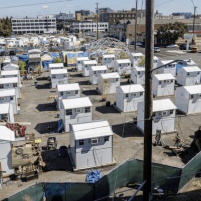 A large number of tents in a parking lot.