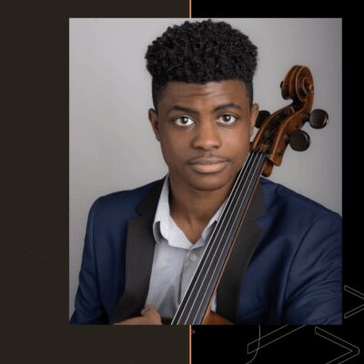 An image of a young man holding a cello.