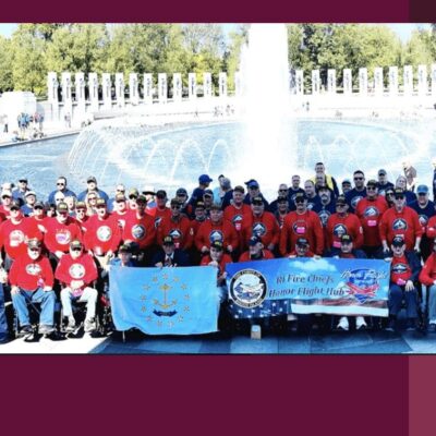 A group of people posing for a photo in front of a fountain.