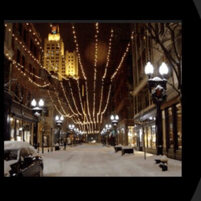 A picture of a snow covered street with lights.