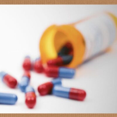 A picture of pills falling out of a medicine bottle.