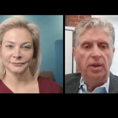 A man and a woman in a video interview.