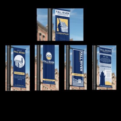 Four banners on a pole in front of a building.