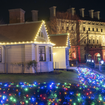 A house with christmas lights in front of it.