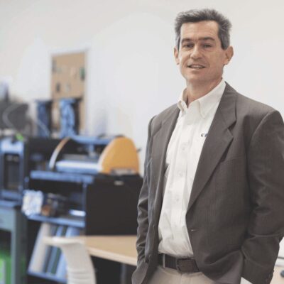 A man in a suit standing in an office.