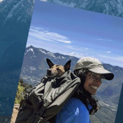 A woman wearing a backpack with a dog on it.