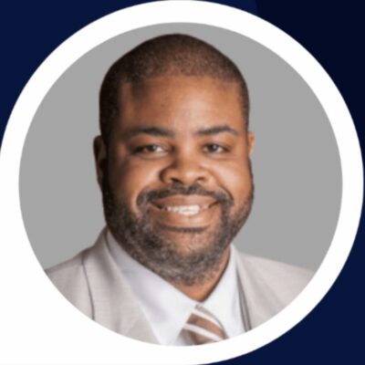A portrait of a black man in a suit and tie.