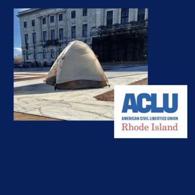 A tent in front of a building with the words aclu rhode island.