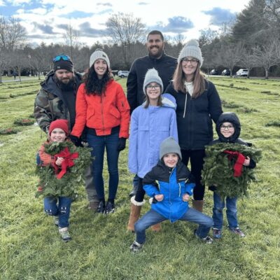 A group of people posing for a photo in a field.