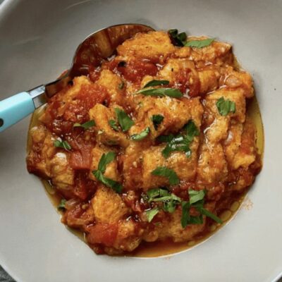 A bowl of food with a spoon.