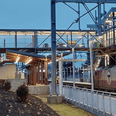 A train pulls into a station at dusk.