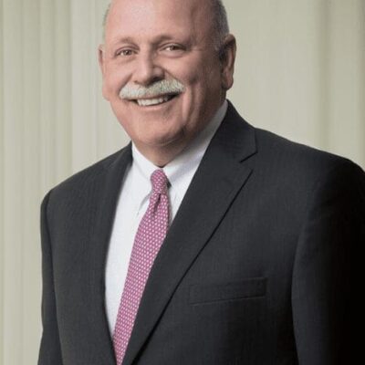 A bald man in a suit and tie.