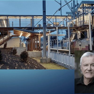 An image of a man standing in front of a building.