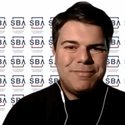 A man in front of a sba logo.